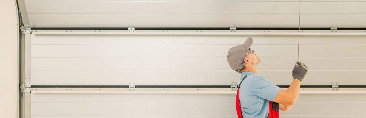 A garage door service man testing the balance